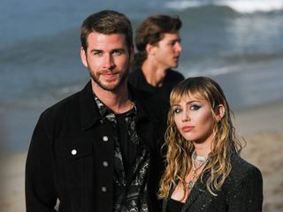 Liam Hemsworth and Miley Cyrus attend a Saint Laurent show in Malibu, California, in 2019