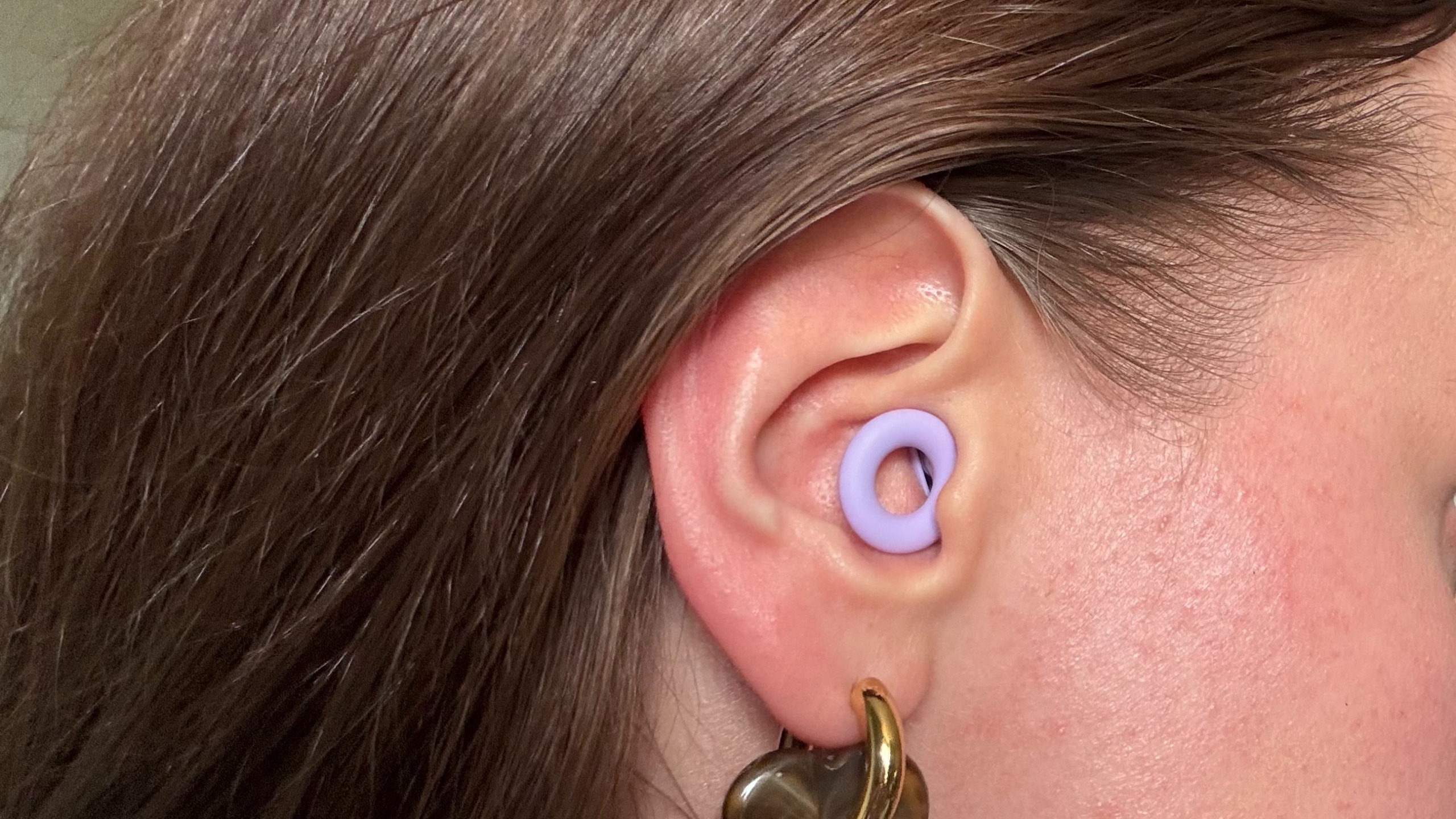The Loop Quiet 2 Earplugs in a woman's right ear.