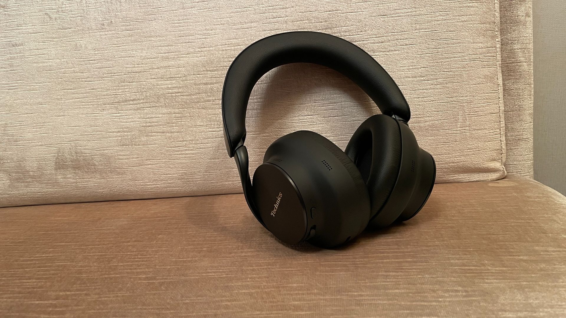 Technics EAH-A1000 in black, in a Tokyo hotel room with the skyline visible