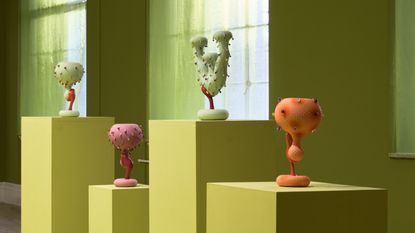 Futuristic ceramics in green gallery space at County Hall Pottery at County Hall Pottery