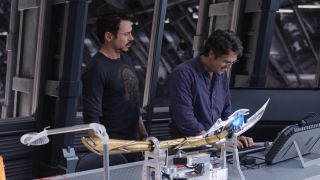 Tony Stark and Bruce Banner at work station studying Loki's scepter