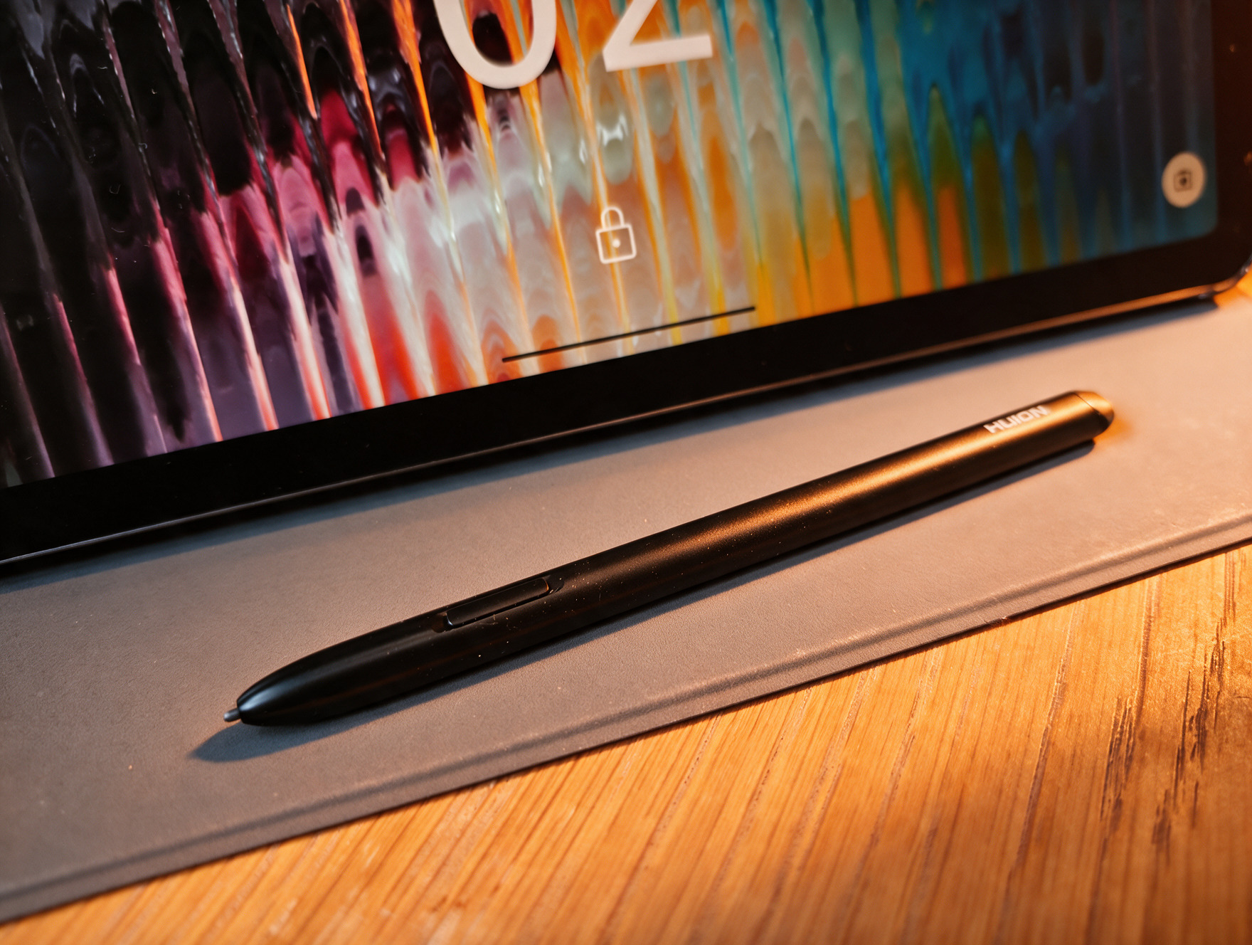 A black Android drawing tablet on a wooden table