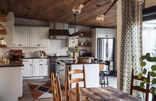 rustic kitchen with wooden ceiling and white metro tiles