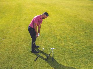 Golf Monthly Top 50 Coach Zane Scotland demonstrating a takeaway drill with golf clubs