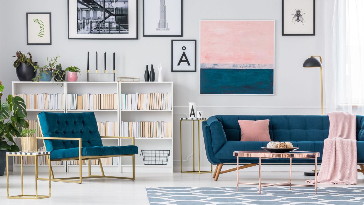 An apartment living room with blue and pink furniture and decorations