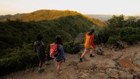 Strava users hike up a mountain during the golden hour on a clear day