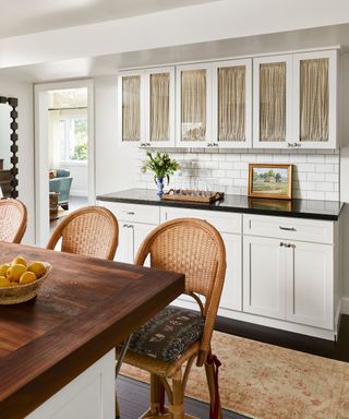 kitchen with white units and rattan stools
