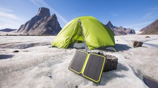 eco camping: tent set up with solar charger