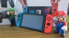 Nintendo Switch (original) with Mario and Luigi figures