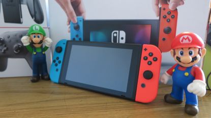 Nintendo Switch (original) with Mario and Luigi figures
