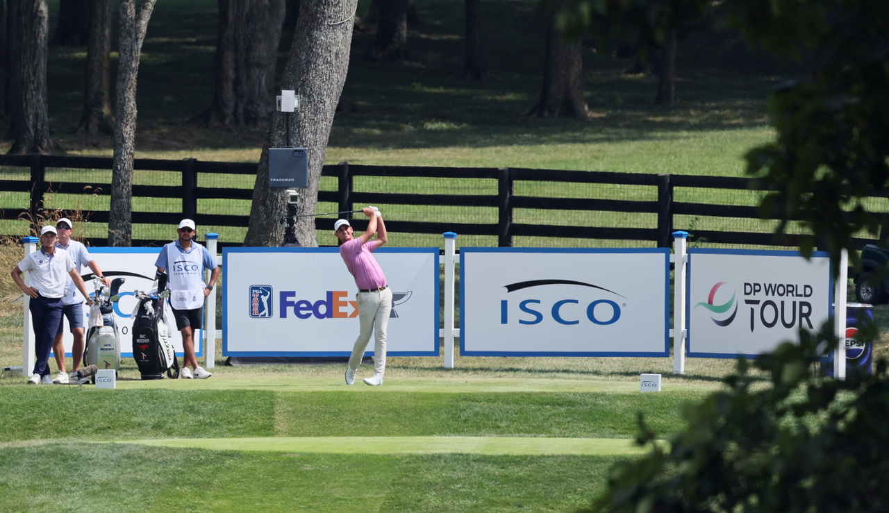 A golfer strikes a tee shot at the ISCO Championship 