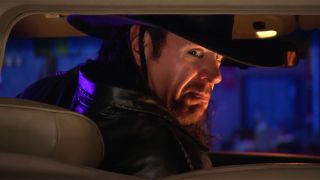 The Undertaker turning around while driving.