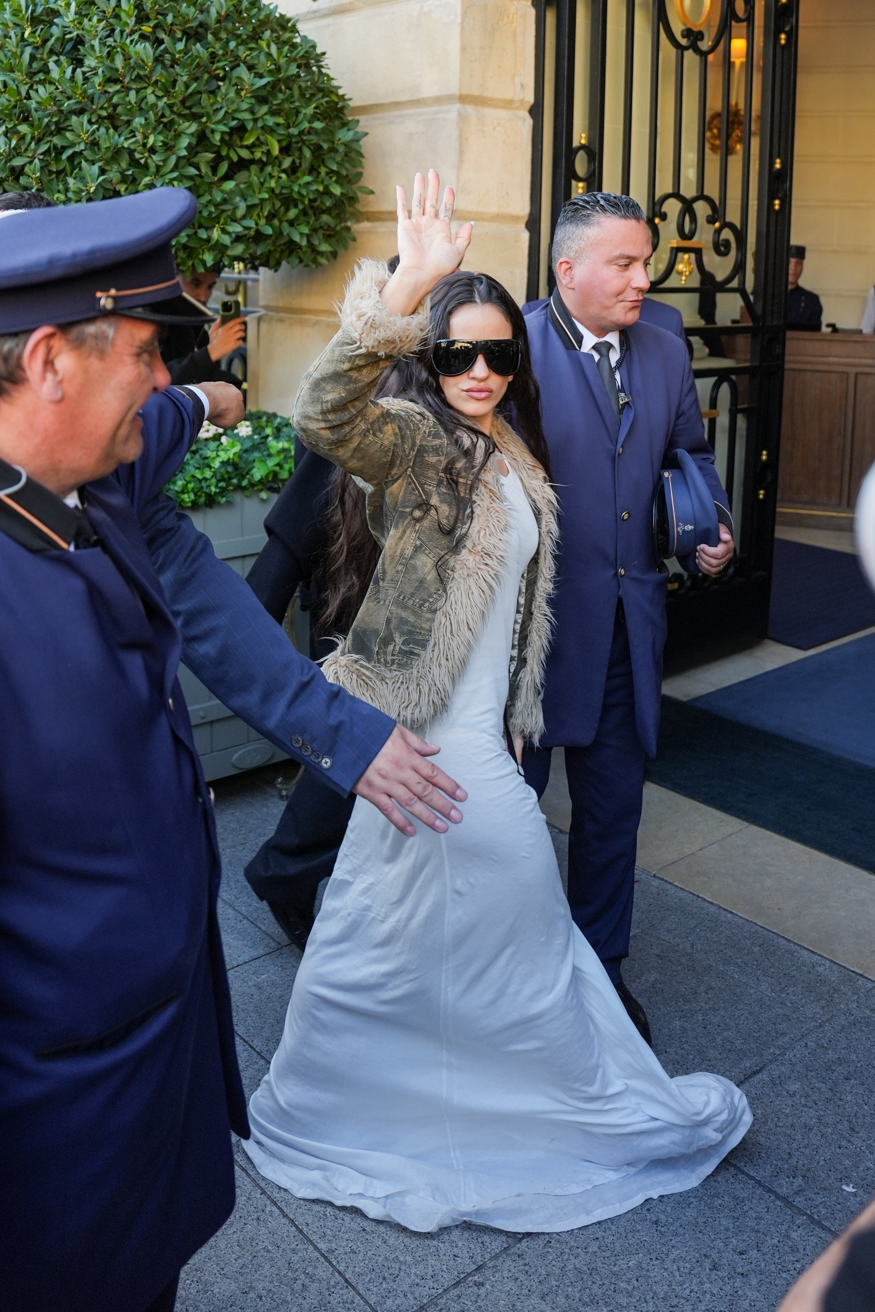 Rosalia was spotted at paris fashion week wearing a camouflage take on the penny lane coat trend