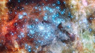 A cluster of shiny blue stars amongst the star-forming clouds of the Tarantula Nebula 
