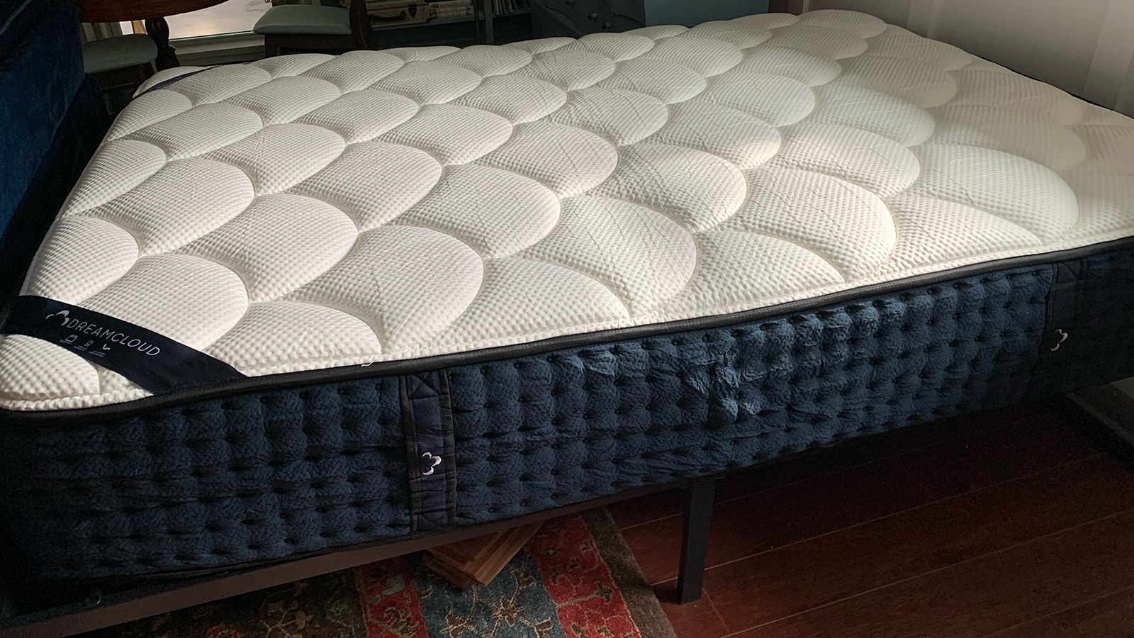 DreamCloud Luxury Hybrid Mattress uncovered on a bed frame
