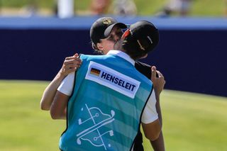 Ester Henseleit and her caddie and fiance celebrate