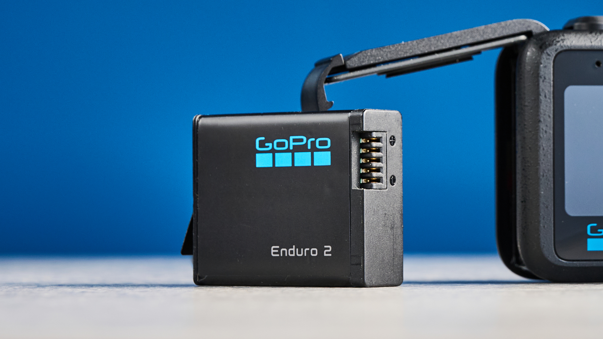 The GoPro Mission 1 Pro Enduro 2 battery against a blue background