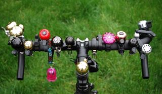 Handlebars of a bike with a selection of the best bike bells mounted