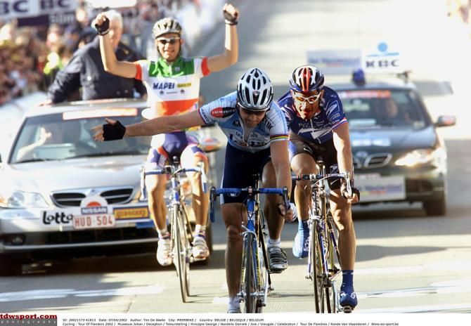 Italian champ Daniele Nardello celebrates his teammate Andrea Tafi's victory as Johan Museeuw takes second