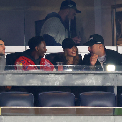 Jerrod Carmichael, Taylor Swift and Travis Kelce attend Game One of the American League Championship Series between the Cleveland Guardians and the New York Yankees at Yankee Stadium on October 14, 2024 in New York City.