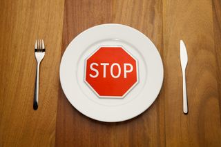 A small stop sign in the middle of dinner plate