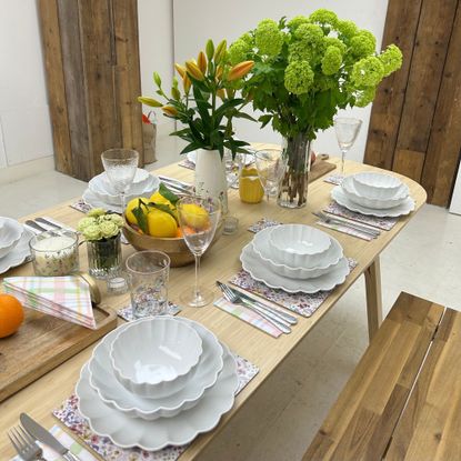 A summer tablescape with a white scalloped dining set on show