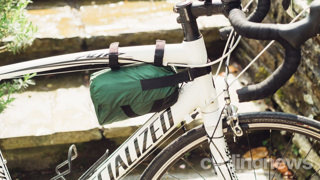 A bike cover strapped to the front of a bike frame