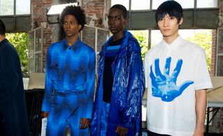 Models wear blue shirt, trousers, jacket and printed shirt at Dries Van Noten S/S 2019
