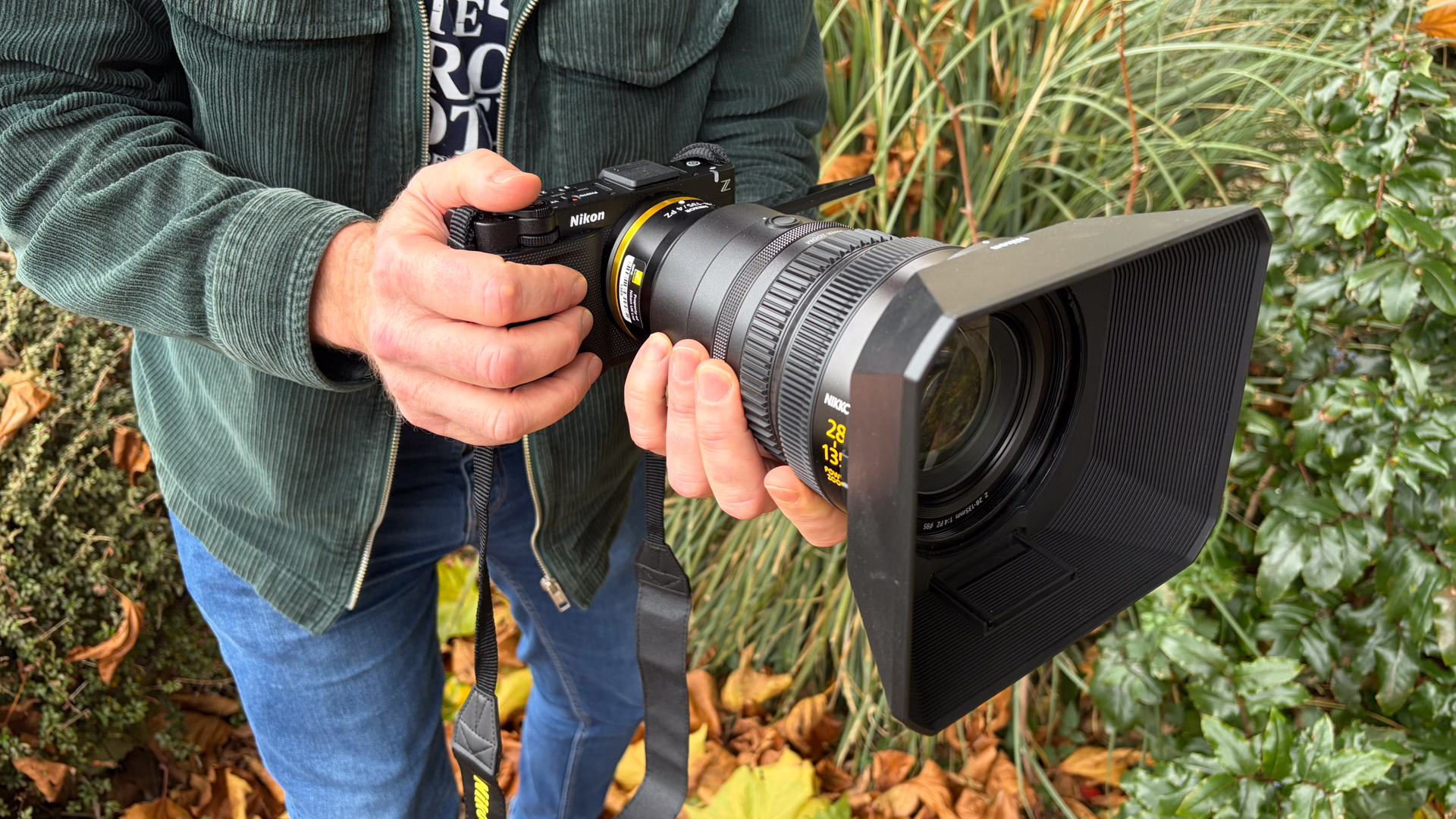 Person holding a Nikon ZR with Z 28-135mm f/4 PZ lens
