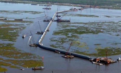 Boats and cranes attempted to stop the oil from reaching New Orleans.