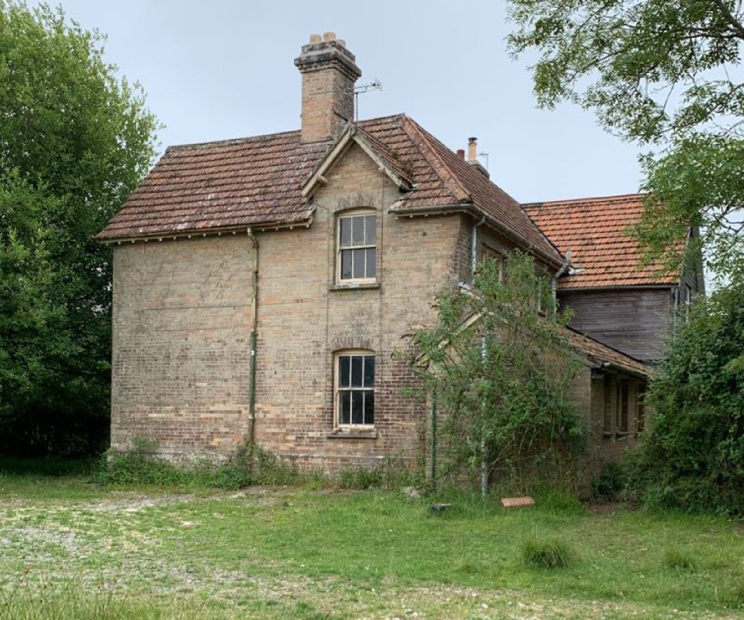Image of a detached brick home before a contemporary renovation took place
