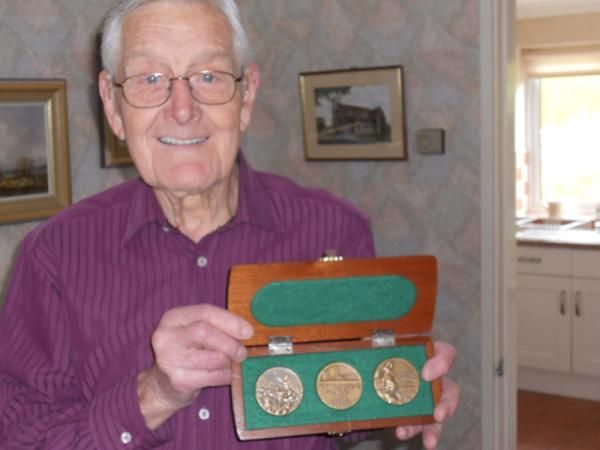Tommy Godwin with his collection of medals