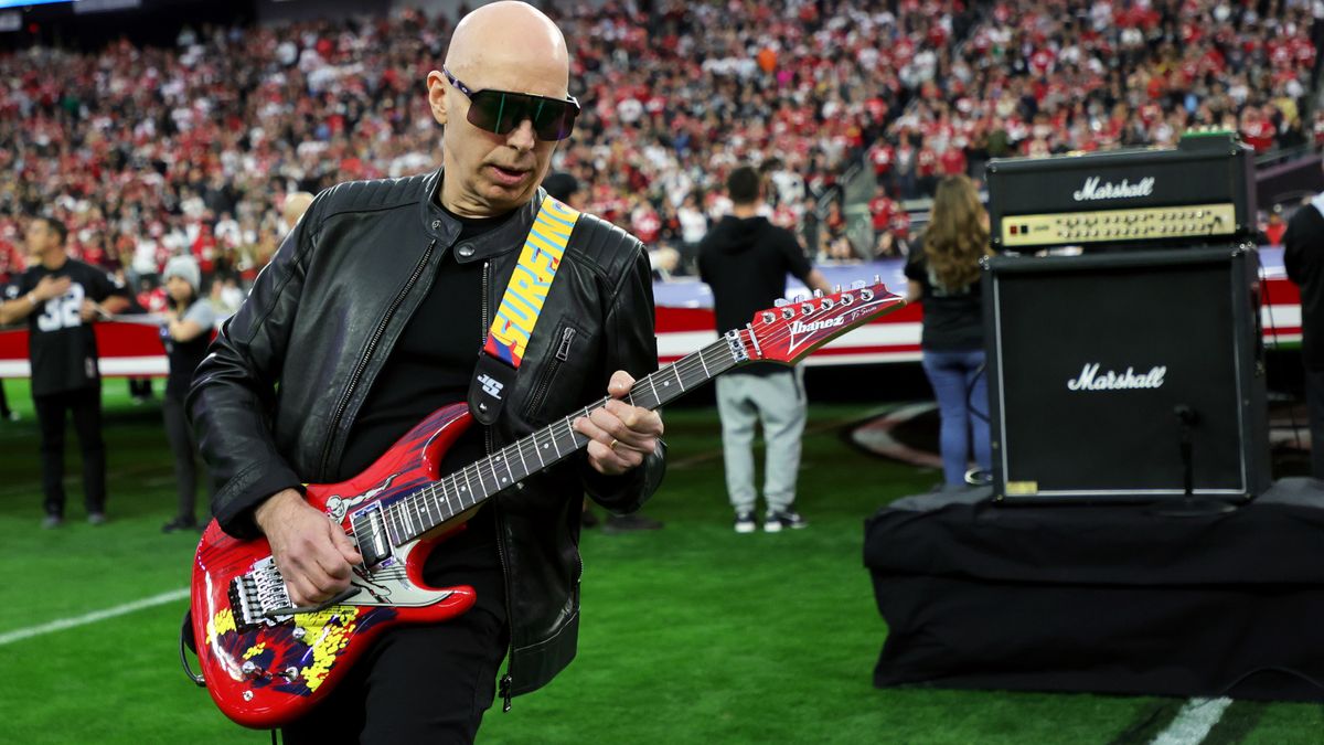 Joe Satriani performs the American national anthem on his signature Ibanez JS20 guitar with the Silver Surfer graphic from his &quot;Surfing With the Alien&quot; album on it before a game between the San Francisco 49ers and the Las Vegas Raiders at Allegiant Stadium on January 01, 2023 in Las Vegas, Nevada. The 49ers defeated the Raiders 37-34 in overtime.