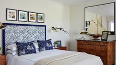 white and blue bedroom with nautical theme and large mirror