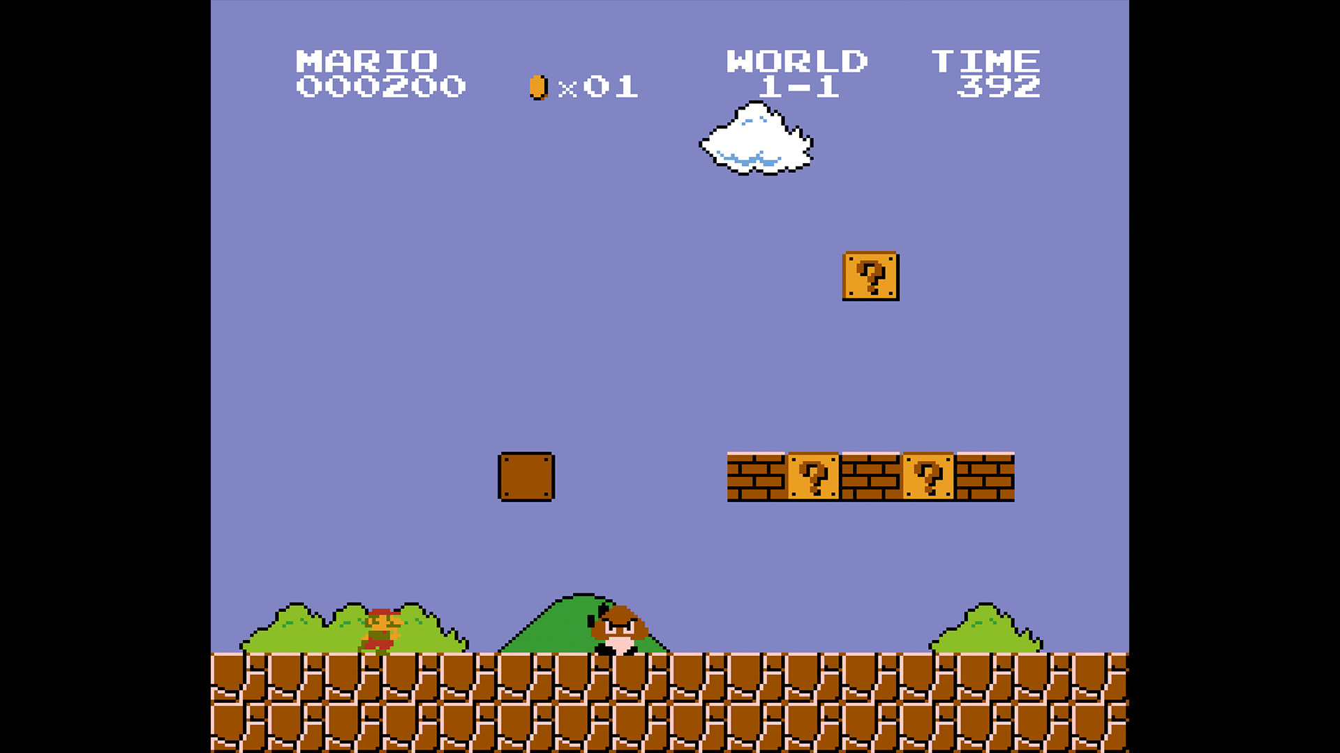 The very beginning of Super Mario Bros, showing a small Mario at the iconic pyramid shaped bricks with a goomba advancing, a brick floor with blue sky in the background and a smattering of green trees and hills - from Retro Gamer 252