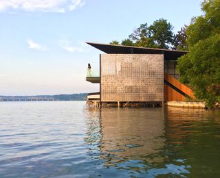 view from the water at Filtered Frame Dock boathouse by Matt Fajkus Architecture