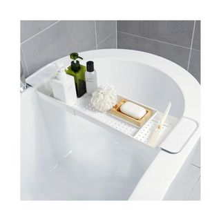 white bathtub tray with bath products on it