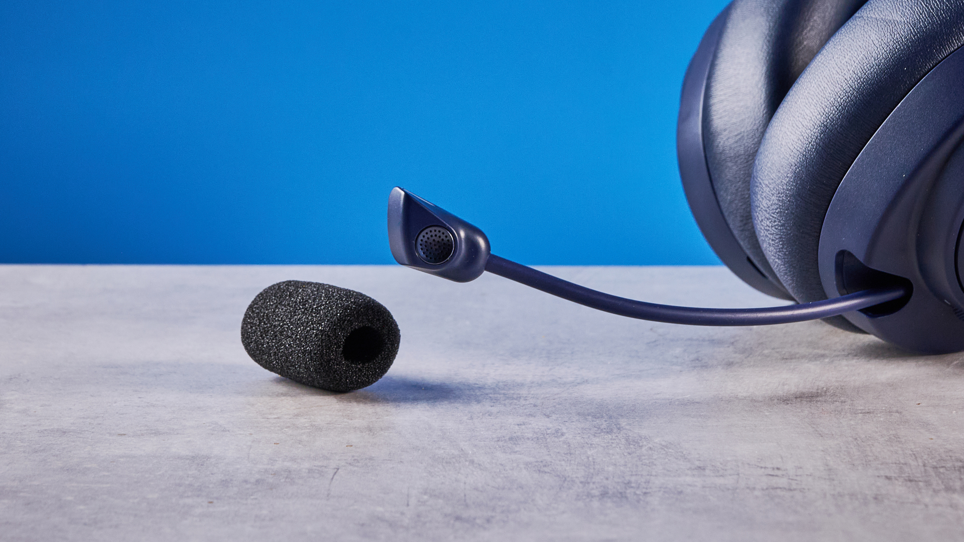 The SteelSeries Arctis Nova Pro Omni on a stone surface against a blue background
