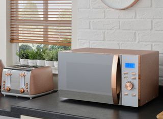 kitchen area with rose gold oven and toaster