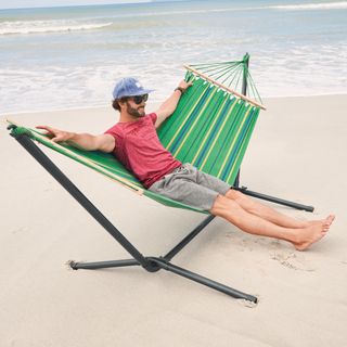 person seating on hammock at beach