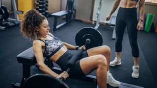 Woman performs hip thrust in gym