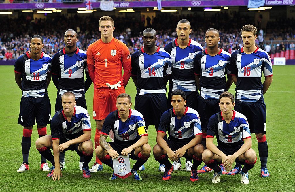 Britain&#039;s players (top from L) midfielder Scott Sinclair, forward Daniel Sturridge, goalkeeper Jack Butland, defenders Micah Richards, Steven Caulker and Ryan Bertrand and midfielder Aaron Ramsey, (bottom from L) midfielder Tom Cleverley, forward Craig Bellamy, defender Neil Taylor and midfielder Joe Allen pose for a team photo before the London 2012 Olympic Games men&#039;s football match between Britain and Uruguay at the Millennium Stadium in Cardiff, Wales, on August 1, 2012. AFP PHOTO / GLYN KIRK (Photo credit should read GLYN KIRK/AFP/GettyImages)