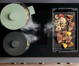 Novy Easy 90 Prestige 90cm Vented Induction Hob With Rotary Dial Controls, two pans on job and rack with grilled meat and vegetables