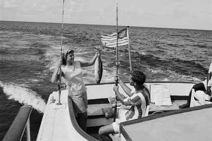 A black and white image of a couple on a boat