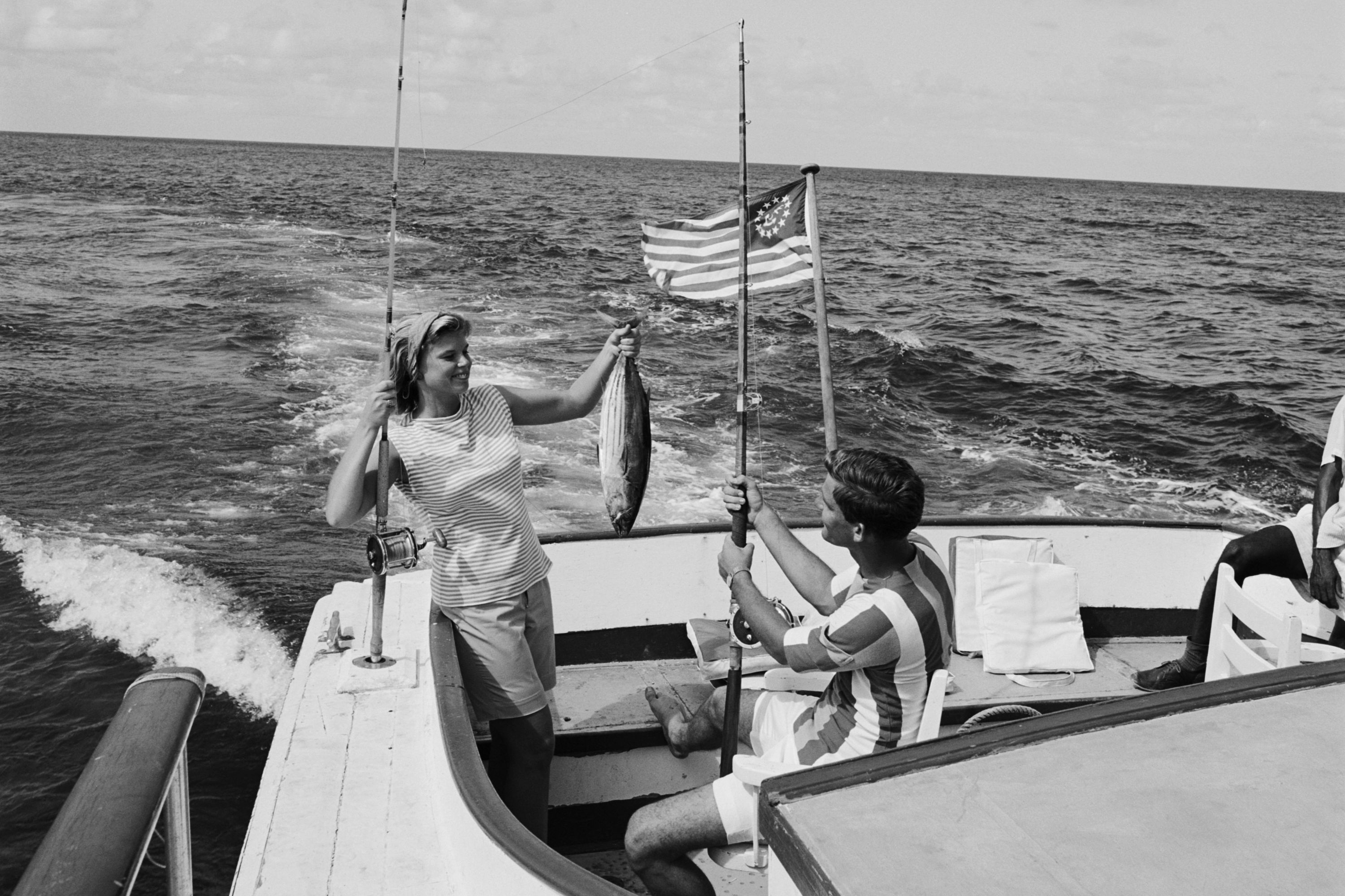 A black and white image of a couple on a boat