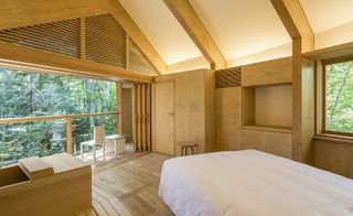 Bedroom with exposed beams and wood furnishings with sliding doors to the balcony