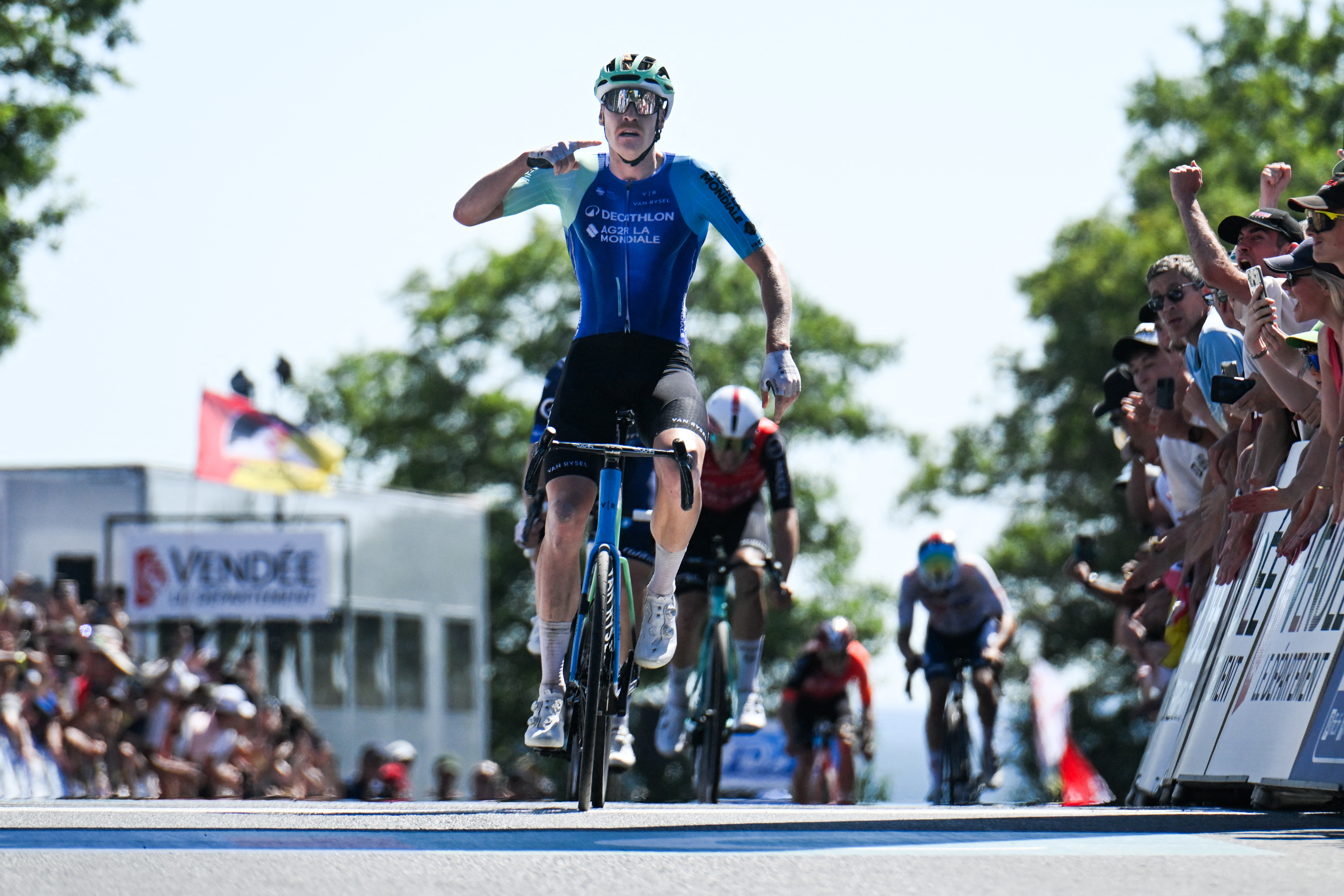Decathlon-AG2R La Mondiale&#039;s French rider Dorian Godon gestures as he crosses the finish line to win the men&amp;rsquo;s Elite race of the French National Road Cycling championships, in Les Herbiers, western France, on June 29, 2025. (Photo by Sebastien Salom-Gomis / AFP)