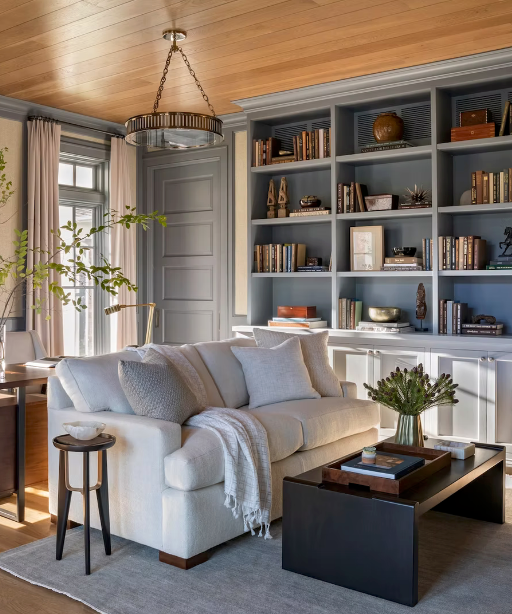 Small living room with white sofa and blue cabinets