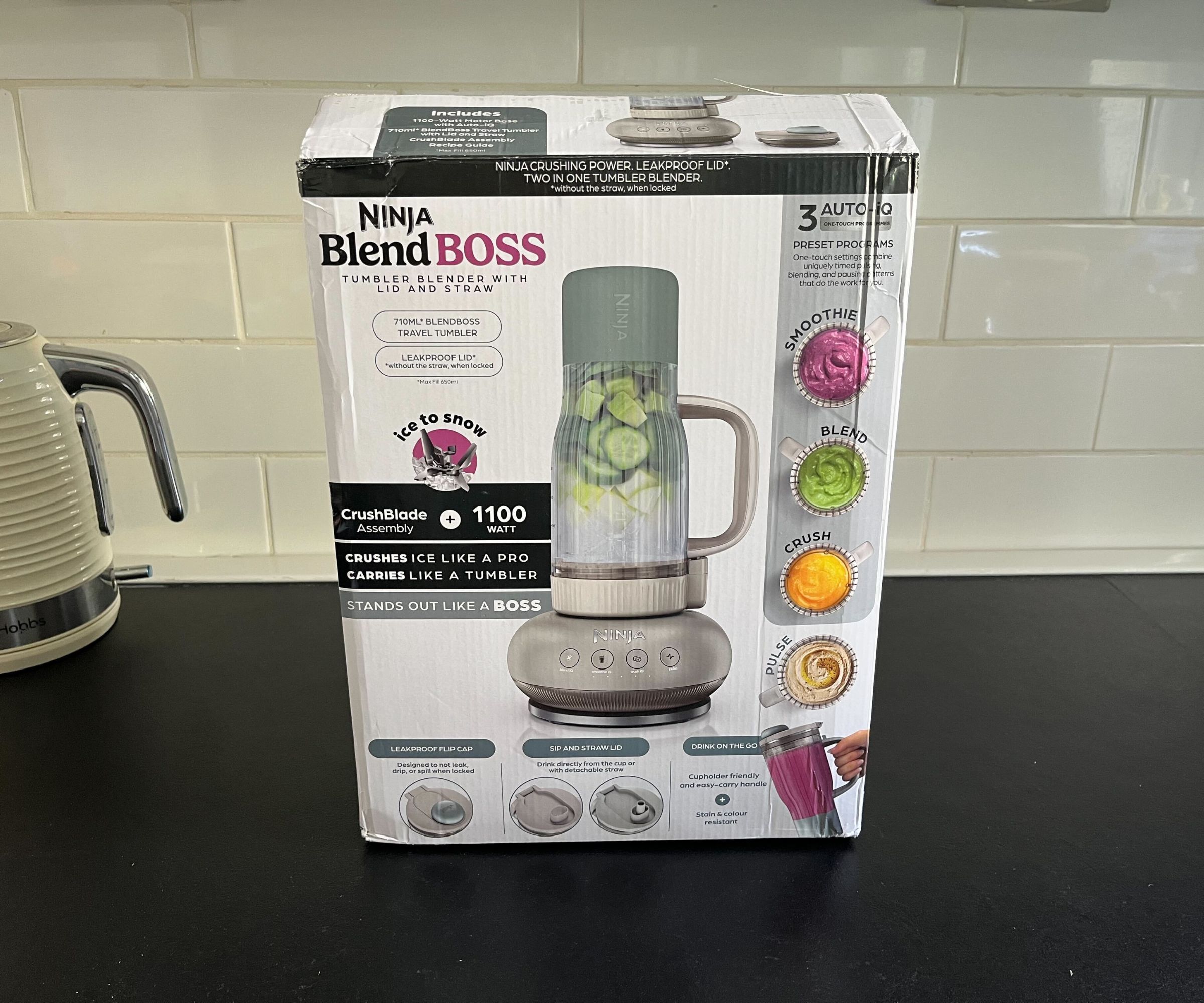The box for the Ninja Blendboss blender on a black counter, with an illustration of the blender on the front. 