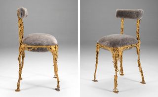A chair with a bronze sculpted frame and a grey furry cushion and backrest.